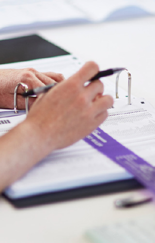 Staff member marking names off the electoral roll